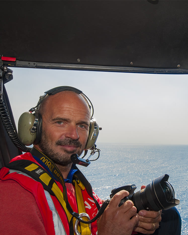 Martino Motti with his Nikon on board a helicopter over the sea