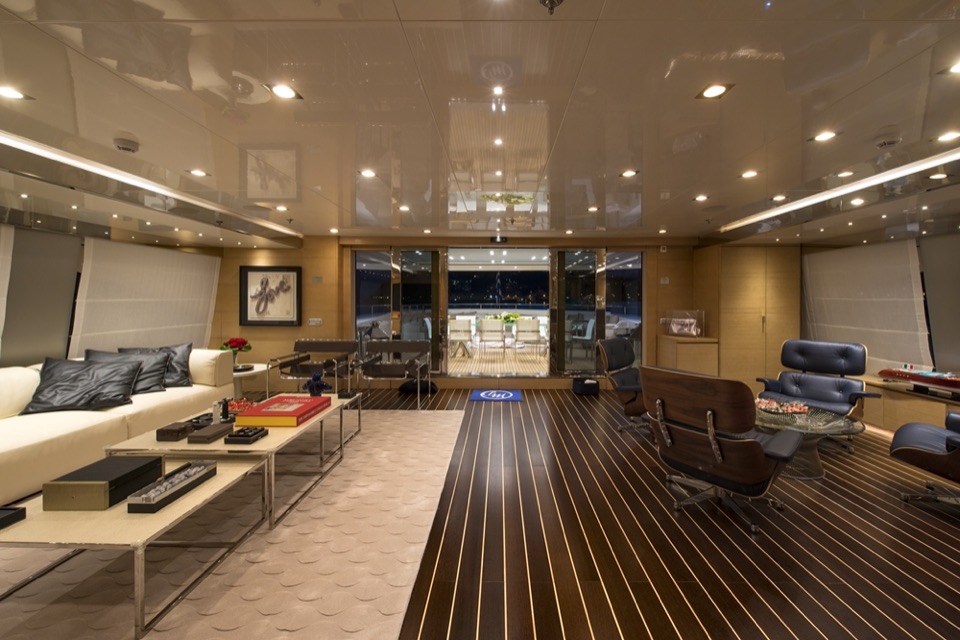 Main saloon of M/Y My Dream with cream sofas and teak floor